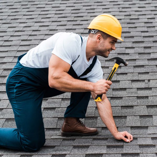 repairman-in-helmet-holding-hammer-while-repairing-2022-12-16-20-00-29-utc.jpg